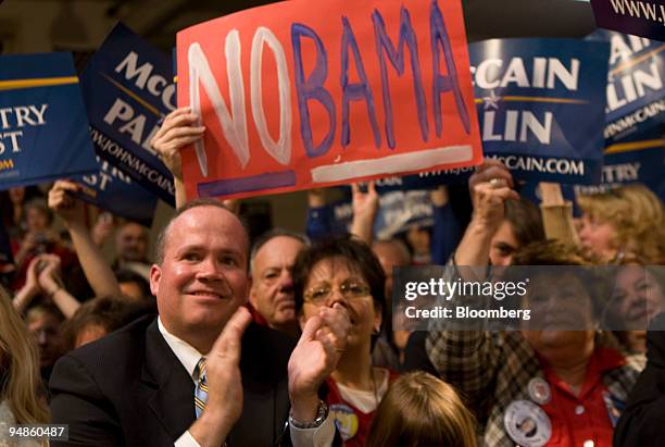 Supporters of Senator John McCain of Arizona, Republican presidential candidate, cheer while he speaks during a campaign rally at the Strath Haven...