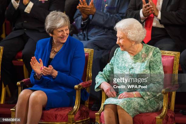 British Prime Minister Theresa May sits with Queen Elizabeth II at the formal opening of the Commonwealth Heads of Government Meeting in the ballroom...