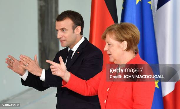German Chancellor Angela Merkel and French President Emmanuel Macron leave a joint press conference on April 19, 2018 in Berlin before holding talks...