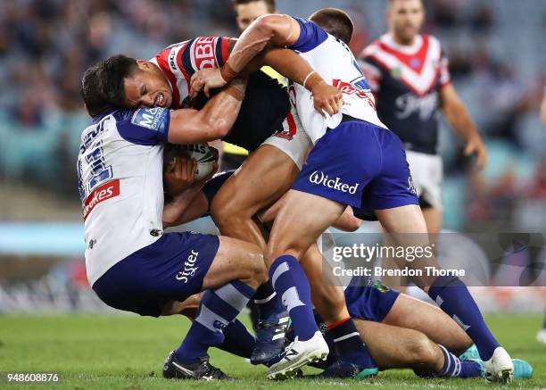 Zane Tetevano of the Roosters is tackled by the Bulldogs defence during the round seven NRL match between the Canterbury Bulldogs and the Sydney...