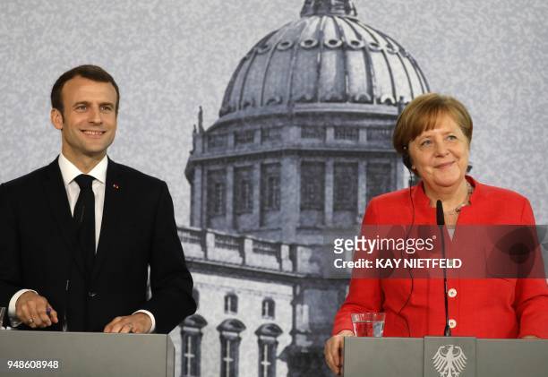 German Chancellor Angela Merkel and French President Emmanuel Macron give a joint press conference on April 19, 2018 in Berlin at the Humboldt Forum...