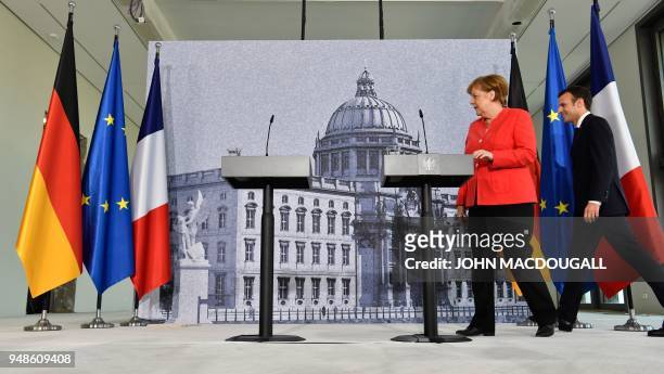 German Chancellor Angela Merkel and French President Emmanuel Macron arrive to give a joint press conference on April 19, 2018 in Berlin before...