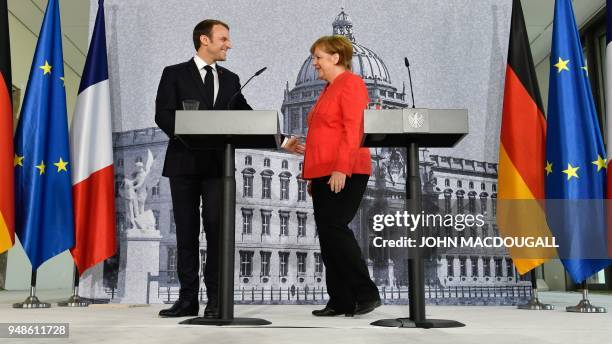 German Chancellor Angela Merkel and French President Emmanuel Macron leave a joint press conference on April 19, 2018 in Berlin before holding talks...