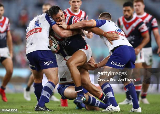 Zane Tetevano of the Roosters is tackled by the Bulldogs defence during the round seven NRL match between the Canterbury Bulldogs and the Sydney...