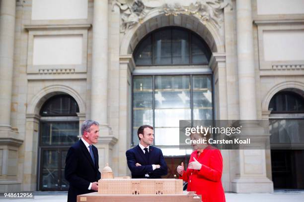 Founding director Neil MacGregor explains German Chancellor Angela Merkel and French President Emmanuel Macron the Humboldt Forum construction site...