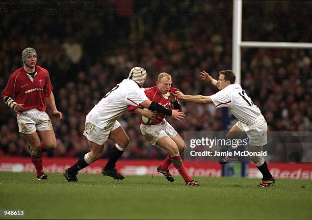 Phil Vickery and Mike Catt of England stop Neil Jenkins of Wales during the Lloyds TSB Six Nations Championship 2001 match played at the Millennium...