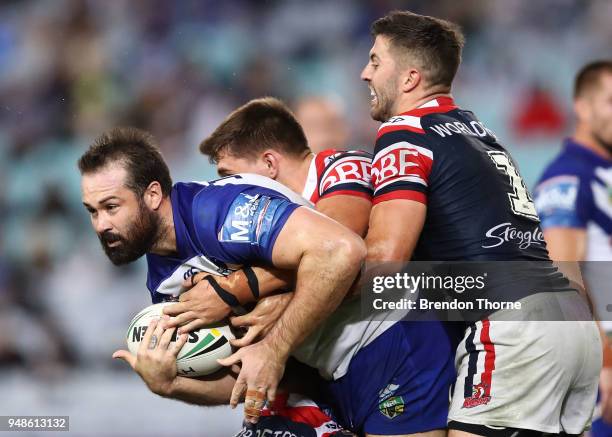 Aaron Woods of the Bulldogs is tackled by Roosters defence during the round seven NRL match between the Canterbury Bulldogs and the Sydney Roosters...