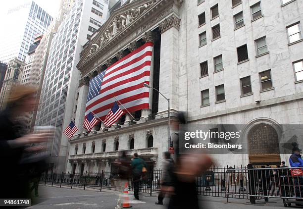 Pedestrians walk past the New York Stock Exchange in New York, U.S., on Wednesday, April 9, 2008. U.S. Stocks fell for a second day, led by retailers...