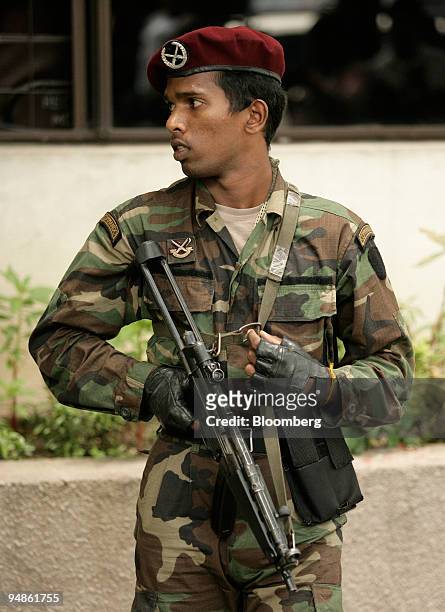 Sri Lankan army commando stands guard as President-elect Mahinda Rajapakse arrives at the Election Commission in Colombo Friday, November 18, 2005....