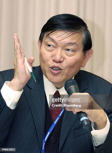 Semiconductor Manufacturing International Corp. Chief executive Richard Chang gestures as he answers a reporter's question at a press briefing in...