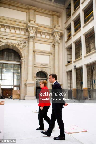 German Chancellor Angela Merkel and French President Emmanuel Macron arrive at the Humboldt Forum construction site on April 19, 2018 in Berlin,...