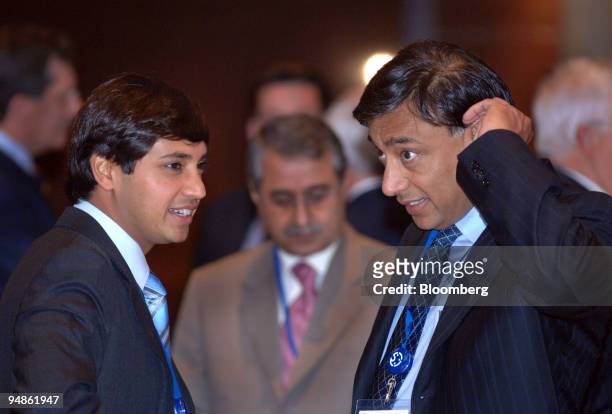 Mittal Steel Chairman & CEO Lakshmi N. Mittal, right, chats with his son, President & CFO, Aditya Mittal during a coffee break at the International...