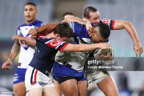 Danny Fualalo of the Bulldogs is tackled by Roosters defence during the round seven NRL match between the Canterbury Bulldogs and the Sydney Roosters...