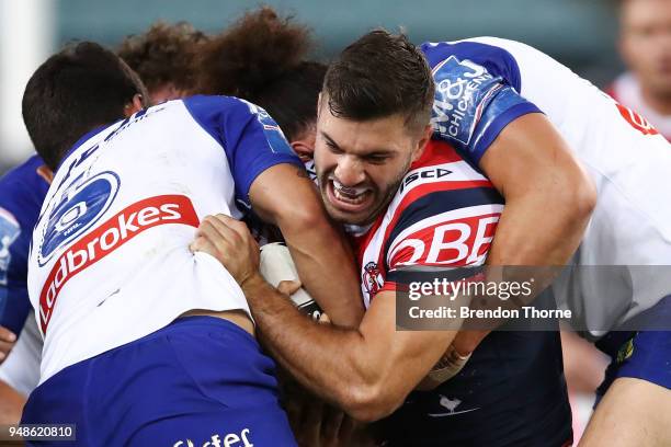 James Tedesco of the Roosters is tackled by the Bulldogs defence during the round seven NRL match between the Canterbury Bulldogs and the Sydney...