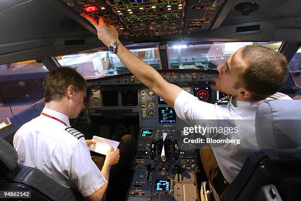 Virgin Atlantic Captain David Tilton and co-pilot Paul Howe do a pre-flight check in the cockpit of an Airbus A34-400, before the aircraft pushes...
