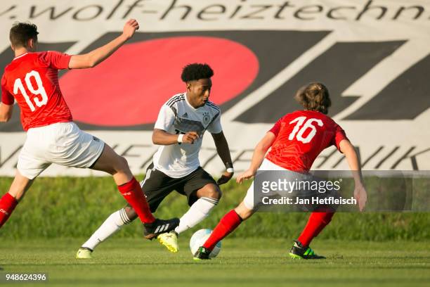 John Yeboah of Germany, Felix Bacher of Austria and Lukas Sulzbacher of Austria fight for the ball during the International friendly match between...