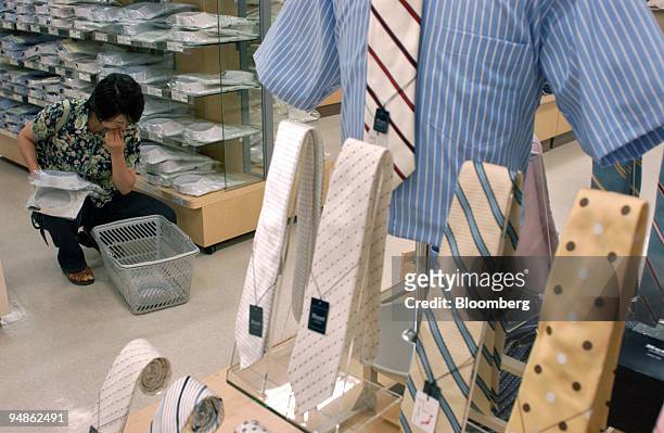 Woman shops in the clothing section of an Ito Yokado department store in Tokyo, Japan Tuesday, June 28, 2005. Japan's retail sales fell in May as...