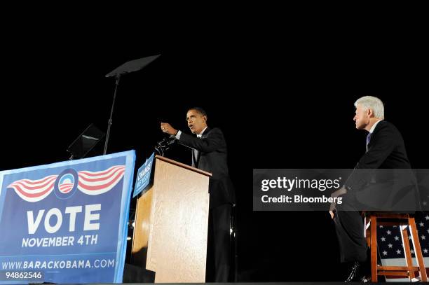 Former U.S. President Bill Clinton, right, looks on as Senator Barack Obama of Illinois, Democratic presidential candidate, speaks to the crowd at a...