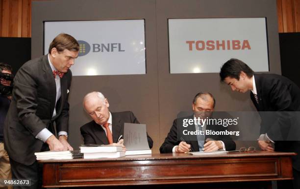 Atsutoshi Nishida, chief executive officer Toshiba Corp., and Mike Parker chief executive officer BNFL, are seen during a signing ceremony in London,...