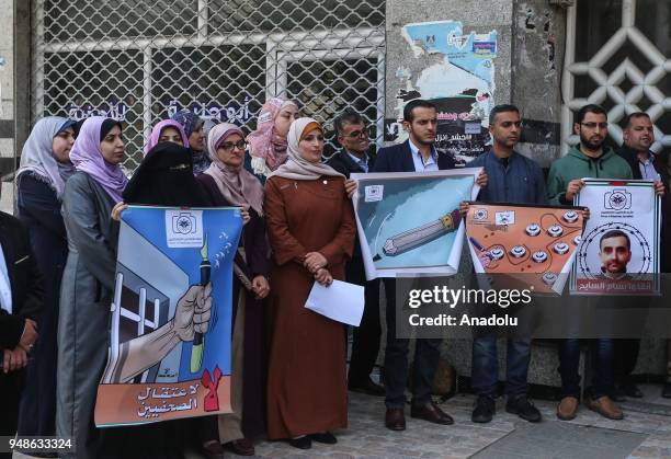 Palestinian journalists hold banners and shout slogans as they gather for a demonstration to show their support to their Palestinian counterparts in...