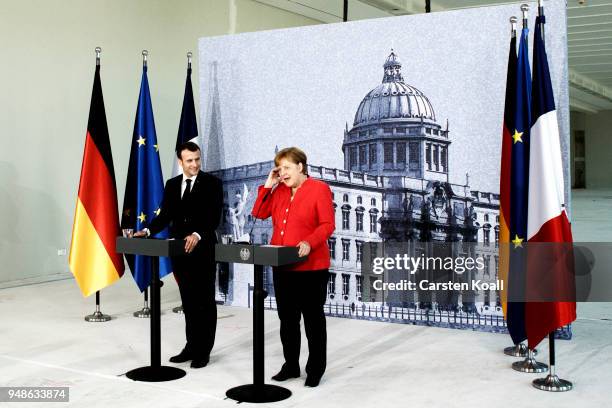 German Chancellor Angela Merkel and French President Emmanuel Macron attend a pressconference following a visit in the Humboldt Forum construction...