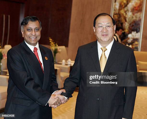 Chinese Finance Minister Jin Renqing, right, shakes hands with Malaysian 2nd Finance Minister Mohamed Yakcop Sunday, June 26, 2005 during a...