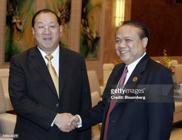 Chinese Finance Minister Jin Renqing, left, shakes hands with Indonesian Finance Minister Jusuf Anwar Sunday, June 26, 2005 during a bi-lateral...