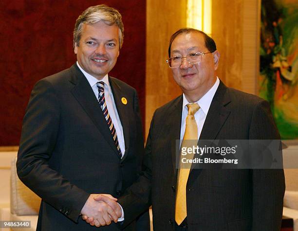 Chinese Finance Minister Jin Renqing, right, shakes hands with Belgian Finance Minister Didier Reynders Sunday, June 26, 2005 during a bi-lateral...