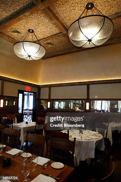 Tables are ready for dinner service under the decorative wine cork-roof at Ago, a restaurant located at 377 Greenwich Street in New York, U.S., on...