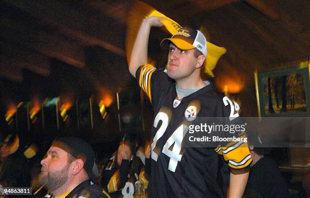 Chris Dountas, right, waves his terrible towel in support of the Pittsburgh Steelers at Al's Cafe in Bethel Park, Pennsylvania, a suburb of...