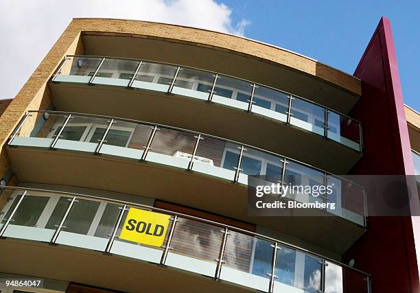 Sold sign hangs on the balcony of a new luxury housing development built by Barratt Developments, in London, U.K., on Wednesday, April 9, 2008. U.K....