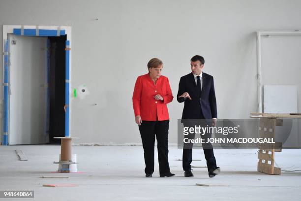 German Chancellor Angela Merkel and French President Emmanuel Macron arrive to give a joint press conference on April 19, 2018 in Berlin before...
