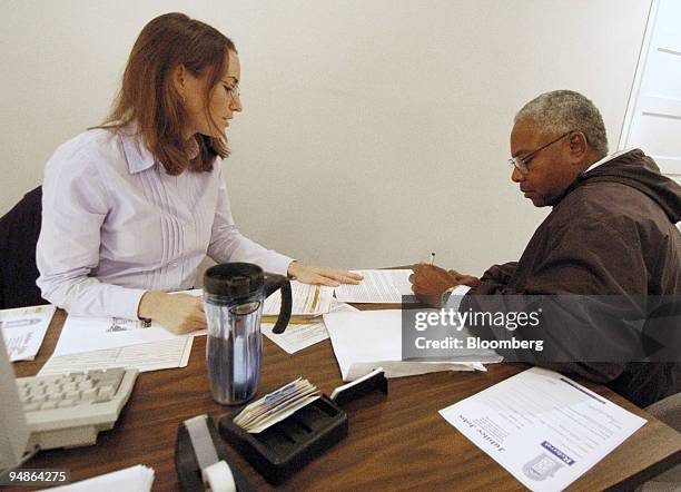 Sara Schell, left, a job counselor at Jubilee Jobs helps client, Alphonzo Dixon, with the job application process in Washington D.C. On Thursday,...