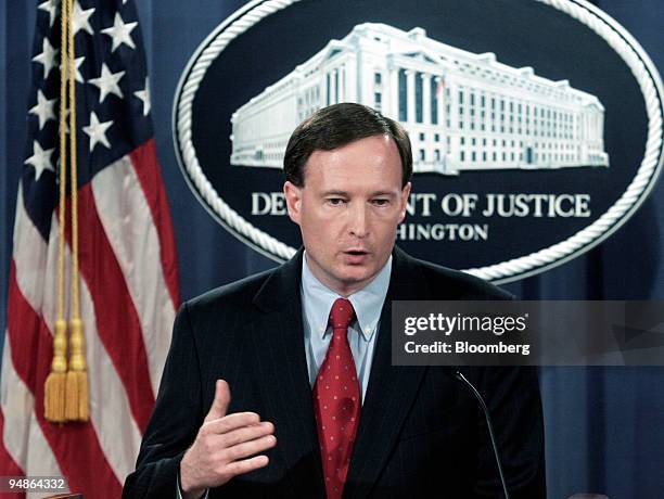 Tom Barnett, acting chief of the Justice Department's anti-trust division, gestures during a news conference at the Department of Justice in...