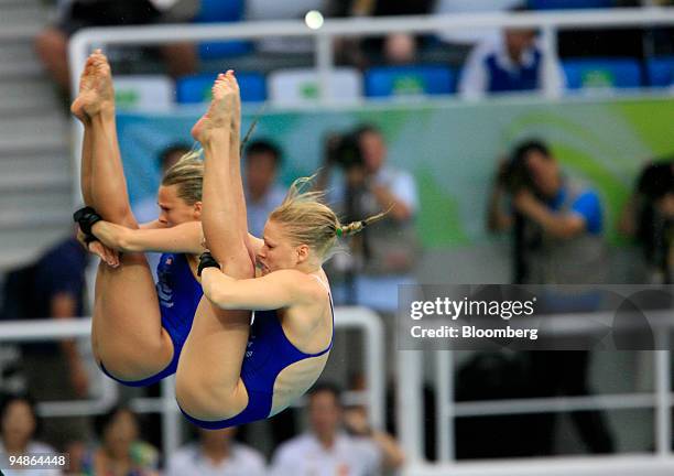 Tonia Couch, right, and Stacie Powell of Great Britain, hold a pike position in the women's 10-meter synchronized diving event during day four of the...