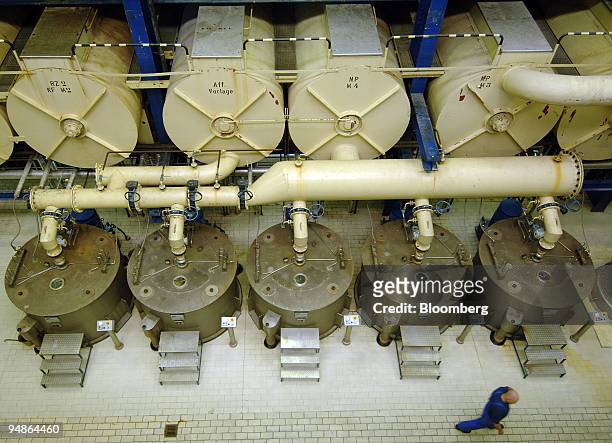 An employee passes vats of syrup in its final phases before being reduced to household sugar at the Suedzucker factory in Gross-Gerau, near Mannheim,...