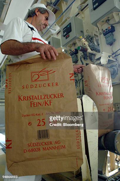 An employee bags sugar at the Suedzucker factory in Gross-Gerau, near Mannheim, Germany, Thursday, October 13, 2005. Shares in Suedzucker, Europe's...