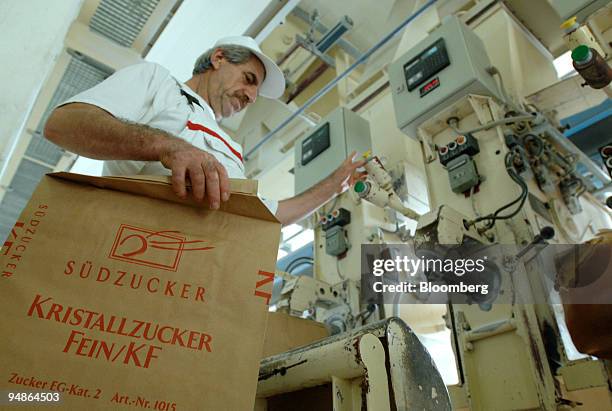 An employee bags sugar at the Suedzucker factory in Gross-Gerau, near Mannheim, Germany, Thursday, October 13, 2005. Shares in Suedzucker, Europe's...