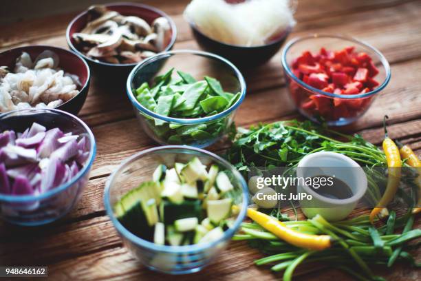 ingredients for thai noodles with prawns - chopping cilantro stock pictures, royalty-free photos & images