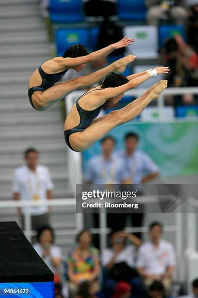 Wang Xin, left, and Chen Ruolin of China, hold a pike position women's 10-meter synchronized diving event during day four of the 2008 Beijing...