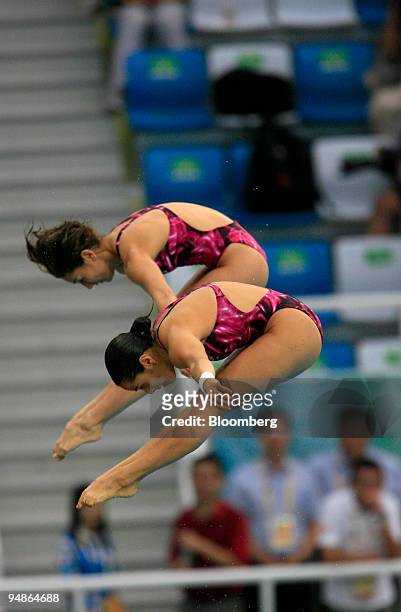 Paola Espinosa, left, and Tatiana Ortiz of Mexico, hold a pike position women's 10-meter synchronized diving event during day four of the 2008...