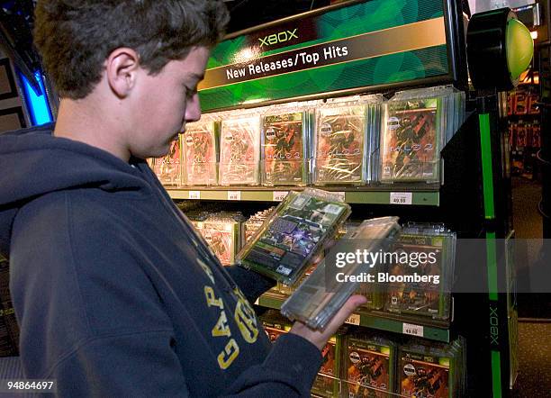 Pablo Sanchez, visiting New York from Mexico City, looks over the Xbox video-game "Halo 2", at the Times Square Toys R Us store in New York on...