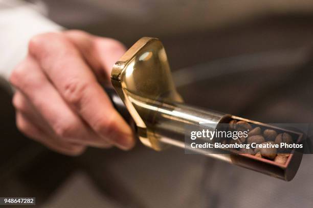 a master roaster selects a sample of coffee beans from a roasting machine - creative selects part i stock pictures, royalty-free photos & images