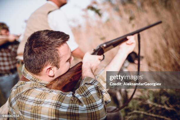 group of hunters with their dogs in action - hobby bird of prey stock pictures, royalty-free photos & images