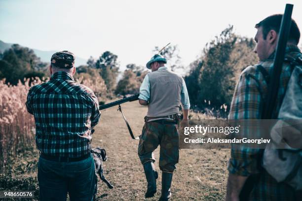 group of hunters with their dogs going for hunting action - hobby bird of prey stock pictures, royalty-free photos & images
