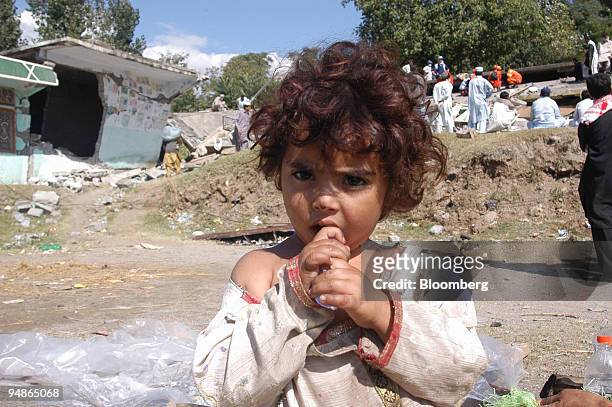 Young girl stands amid the debris of her home in Balakot, northern Pakistan on Wednesday, October 12, 2005. Pakistan's government will immediately...