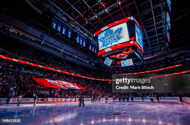 Anthem singer Martina Ortiz-Luis holds up the mic while the crowd sings "O Canada" before the Toronto Maple Leafs play the Boston Bruins in Game...