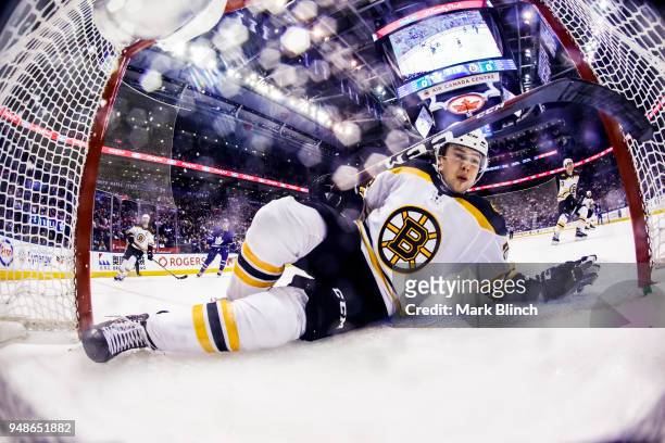 Charlie McAvoy of the Boston Bruins collides with the net against the Toronto Maple Leafs in Game Three of the Eastern Conference First Round during...