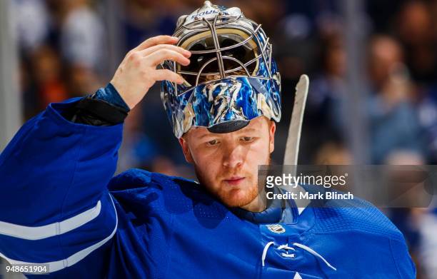 Frederik Andersen of the Toronto Maple Leafs puts on his helmet in a break against the Boston Bruins in Game Three of the Eastern Conference First...