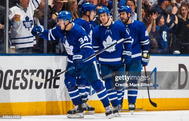 Auston Matthews of the Toronto Maple Leafs celebrates his goal with teammates Zach Hyman, Roman Polak, and Jake Gardiner against the Boston Bruins in...